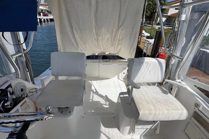 Slide: The Image of 2005 Century 3200 Walk-Around boat interior with two white seats and steering wheel. - 8