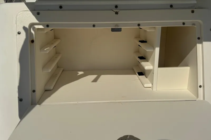 Slide: The Image of Storage compartment of a 2005 Century 3200 Walk-Around boat, featuring multiple shelves. - 80