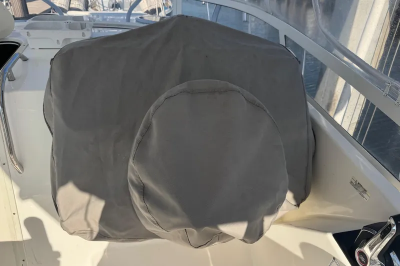 Slide: The Image of Covered helm of a 2005 Century 3200 Walk-Around boat, featuring protective fabric. - 81