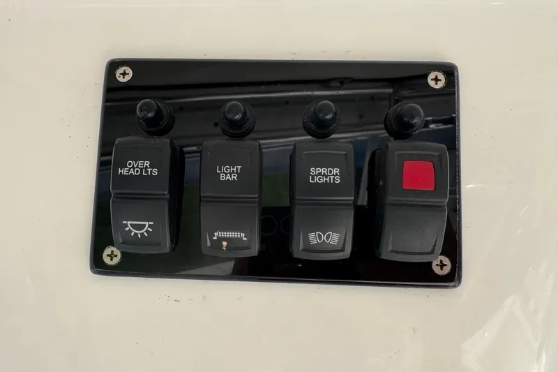 Slide: The Image of Switch panel on 2005 Century 3200 Walk-Around boat with labeled light controls. - 82