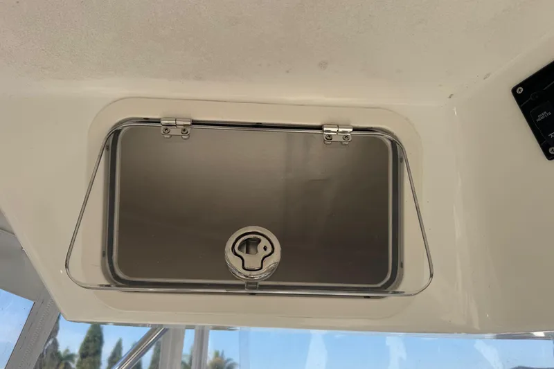 Slide: The Image of Hatch on 2005 Century 3200 Walk-Around boat, featuring secure latch mechanism. - 83
