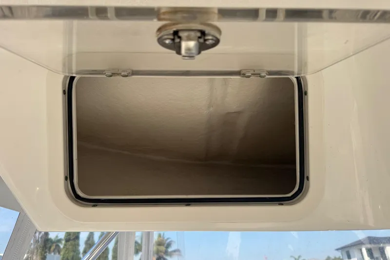 Slide: The Image of Open storage compartment on a 2005 Century 3200 Walk-Around boat. - 84