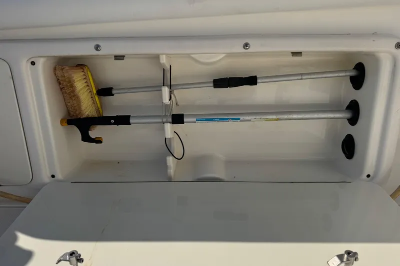 Slide: The Image of Storage compartment on a 2005 Century 3200 Walk-Around boat with cleaning tools. - 85