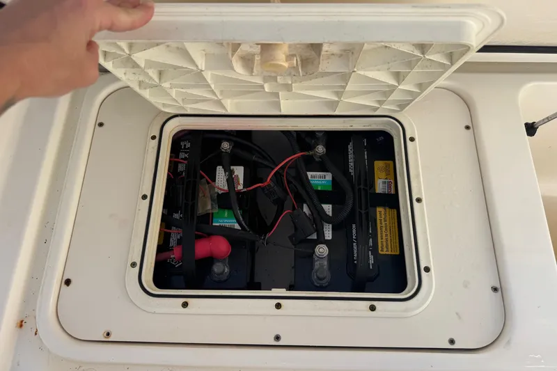 Slide: The Image of Boat battery compartment of 2005 Century 3200 Walk-Around, lid open, showing wiring and connections. - 87