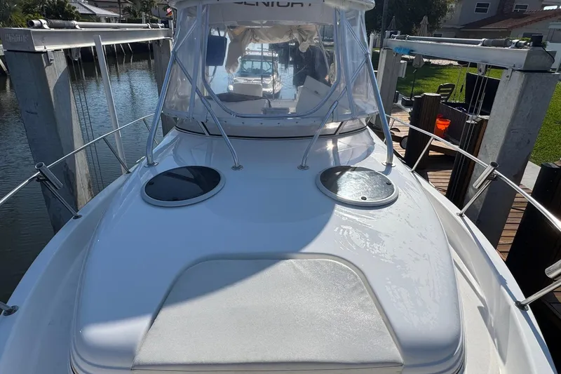 Slide: The Image of 2005 Century 3200 Walk-Around boat docked, featuring sleek design and spacious deck. - 88