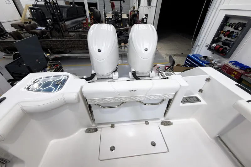 Slide: The Image of 2026 Tidewater 272 CC Adventure boat with dual engines in a workshop setting. - 13