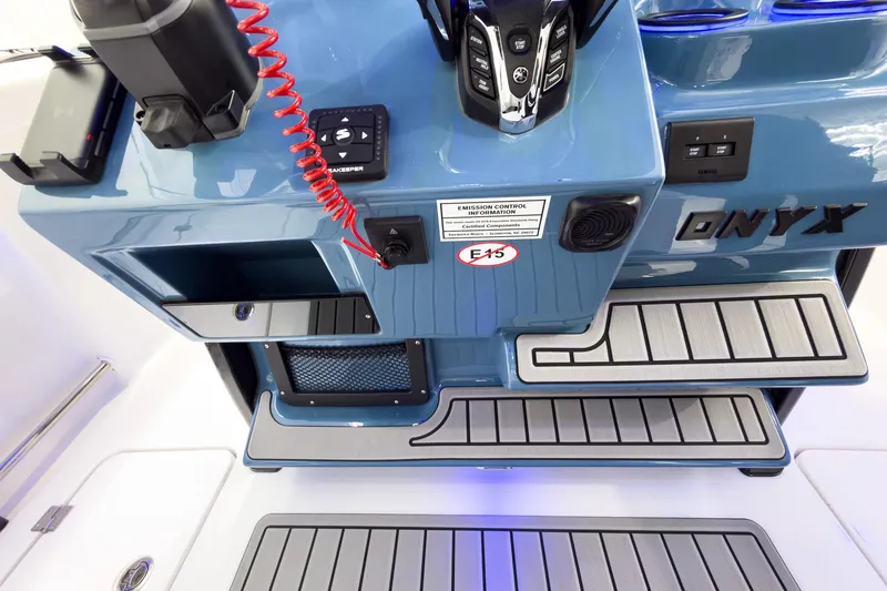 Slide: The Image of 2026 Tidewater 272 CC Adventure boat console with controls and storage compartments. - 22