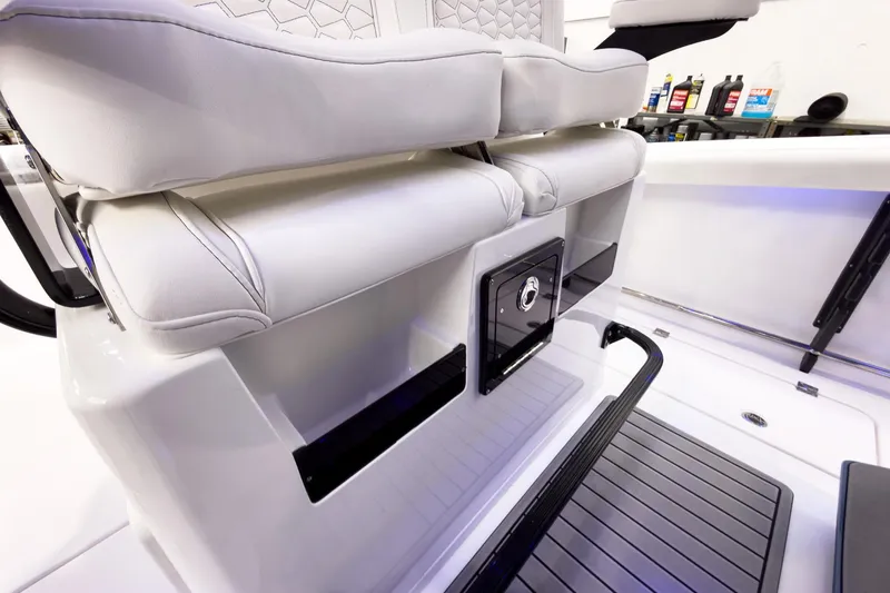 Slide: The Image of 2026 Tidewater 272 CC Adventure boat interior with cushioned seating and storage compartments. - 25