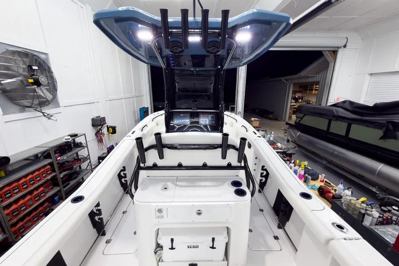Slide: The Image of 2026 Tidewater 272 CC Adventure boat interior in a well-equipped garage setting. - 28
