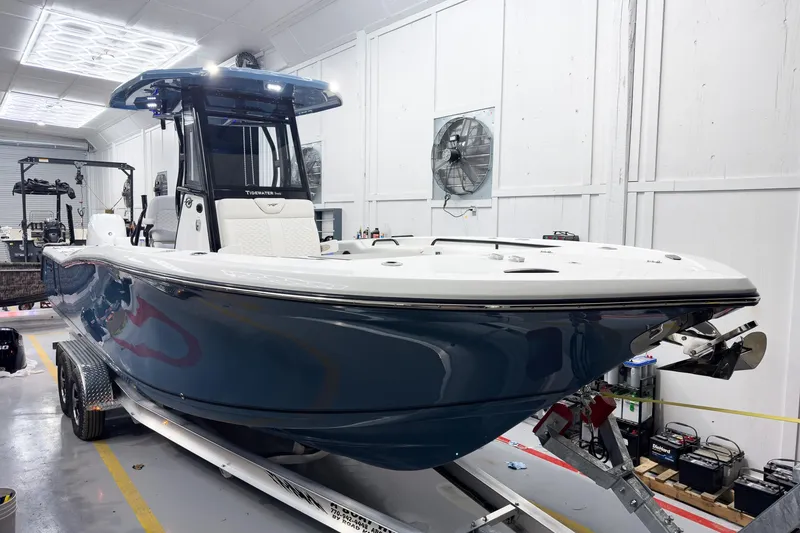 Slide: The Image of 2026 Tidewater 272 CC Adventure boat in a workshop, showcasing sleek design and modern features. - 3