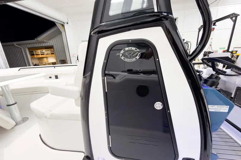 Slide: The Image of 2026 Tidewater 272 CC Adventure boat interior with sleek black and white design. - 38