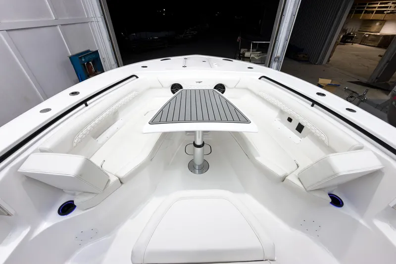Slide: The Image of 2026 Tidewater 272 CC Adventure boat interior with sleek seating and modern table design. - 41