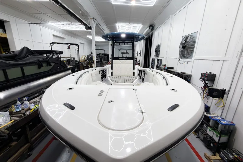 Slide: The Image of 2026 Tidewater 272 CC Adventure boat in a workshop, showcasing sleek design and spacious deck. - 43