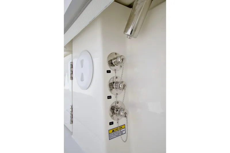 Slide: The Image of 2027 Regulator 35 boat fuel inlets with labeled caps and caution sign. - 44
