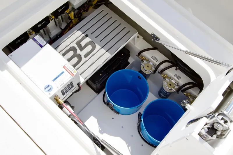 Slide: The Image of Engine compartment of 2027 Regulator 35 boat with blue buckets and mechanical components. - 35