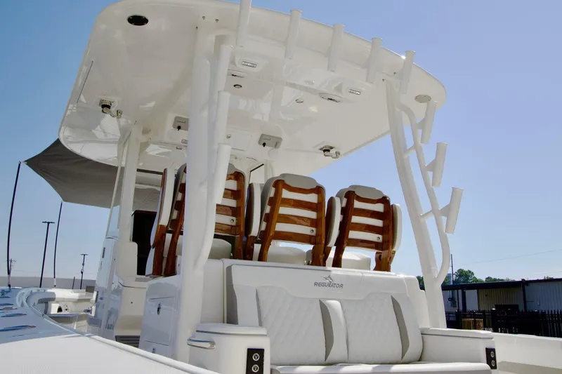 Slide: The Image of 2027 Regulator 35 boat with sleek seating and modern design under a clear sky. - 47