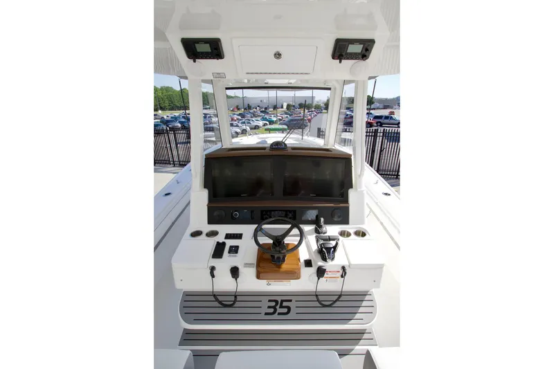 Slide: The Image of 2027 Regulator 35 boat cockpit with steering wheel and control panel. - 42