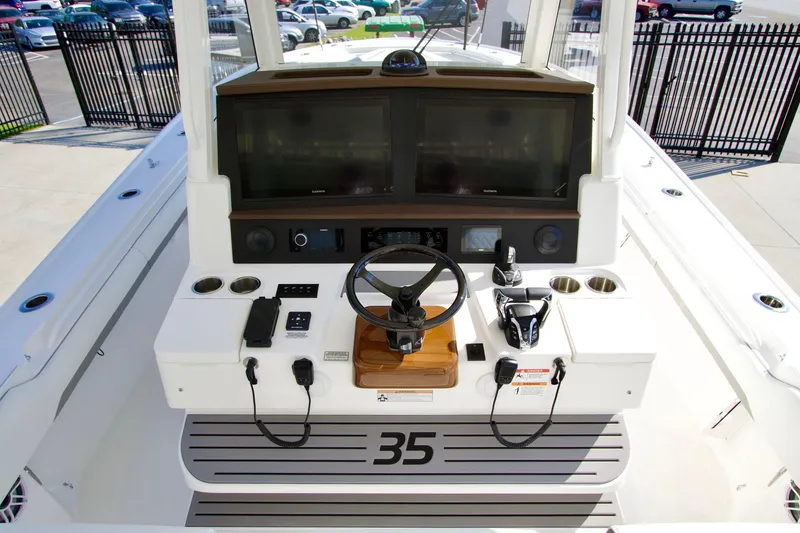 Slide: The Image of 2027 Regulator 35 boat helm with dual screens and modern controls. - 23