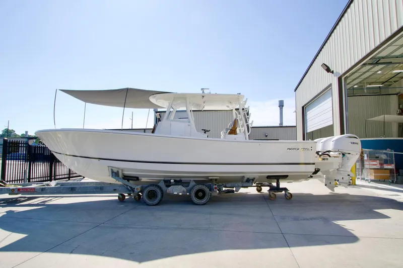 Slide: The Image of 2027 Regulator 35 boat on trailer outside a warehouse, side view. - 45