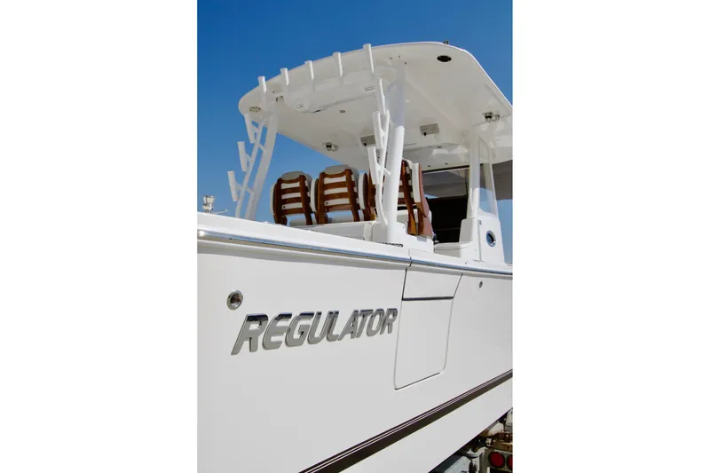 Slide: The Image of 2027 Regulator 35 boat, white exterior, sleek design, clear blue sky background. - 46