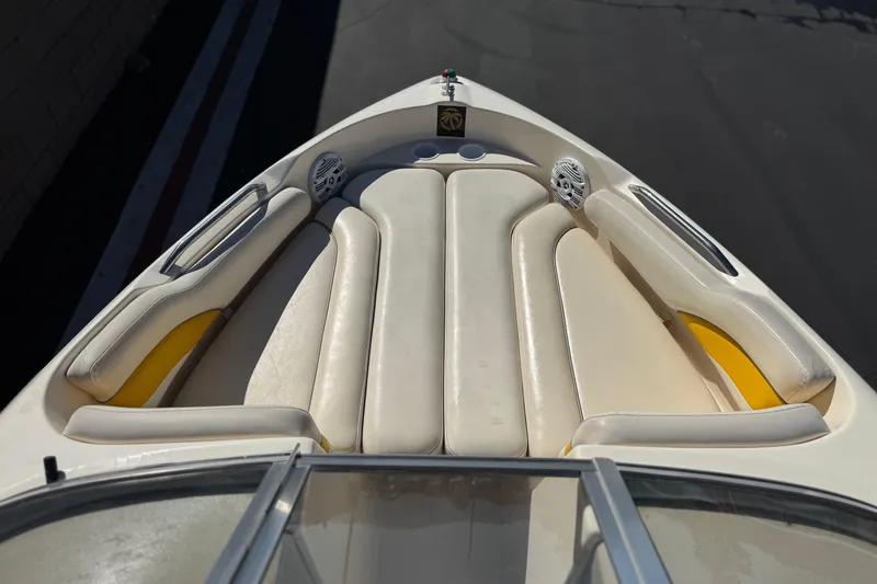 Slide: The Image of 2003 Rinker 192 Captiva Bowrider interior with cream seats and speakers. - 10