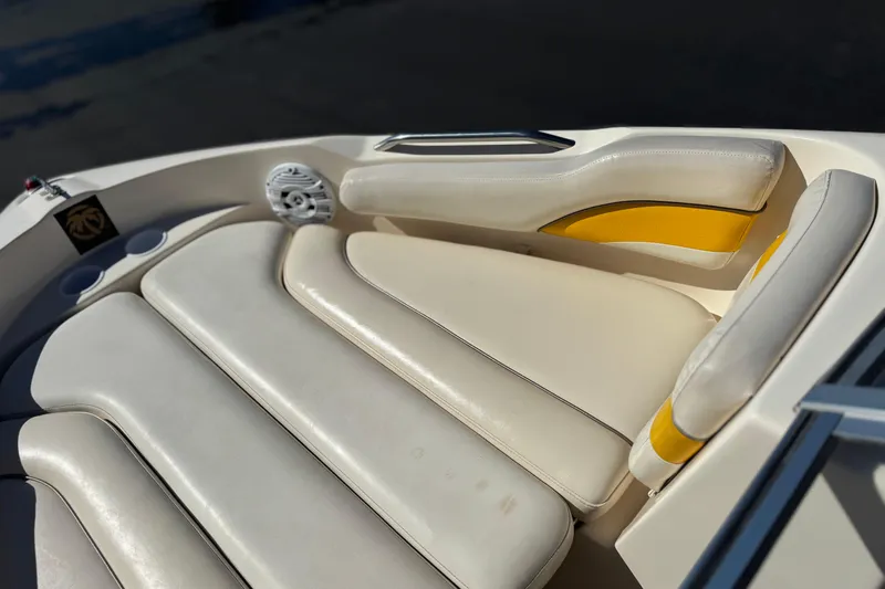 Slide: The Image of 2003 Rinker 192 Captiva Bowrider interior seating with white and yellow upholstery. - 12