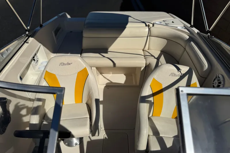 Slide: The Image of 2003 Rinker 192 Captiva Bowrider interior with beige and yellow seating. - 13
