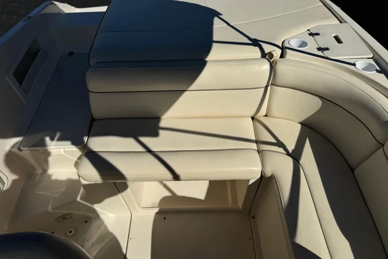 Slide: The Image of 2003 Rinker 192 Captiva Bowrider interior with cream leather seating and cup holders. - 14