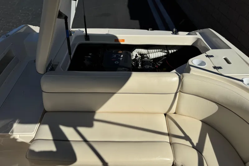 Slide: The Image of 2003 Rinker 192 Captiva Bowrider interior with open engine compartment and beige seating. - 15