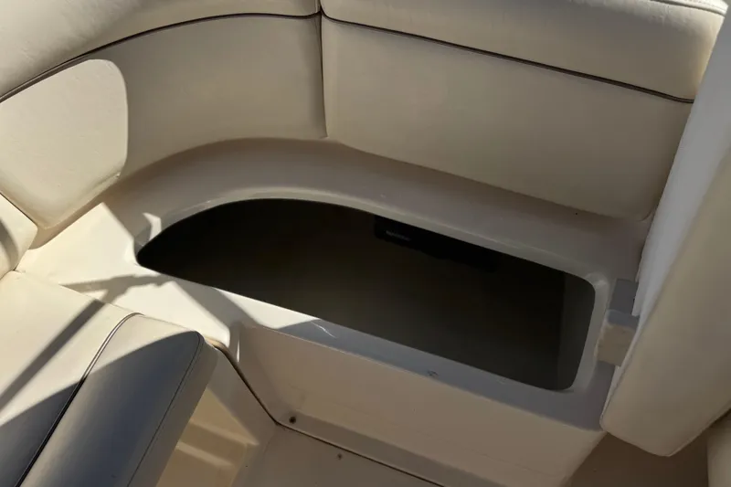 Slide: The Image of Storage compartment in 2003 Rinker 192 Captiva Bowrider boat, featuring cushioned seating. - 17