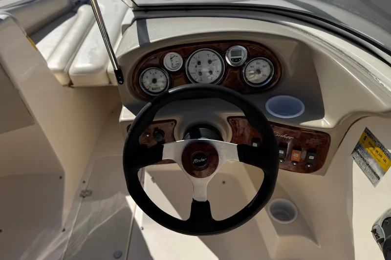 Slide: The Image of Steering wheel and dashboard of 2003 Rinker 192 Captiva Bowrider boat. - 23