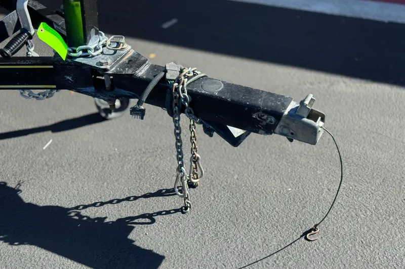 Slide: The Image of Trailer hitch of a 2003 Rinker 192 Captiva Bowrider, secured with chains and locks. - 26