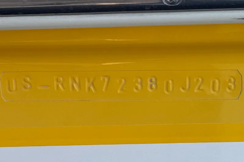 Slide: The Image of Hull identification number on yellow 2003 Rinker 192 Captiva Bowrider boat. - 28