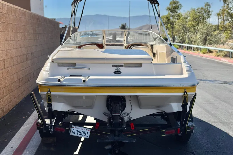 Slide: The Image of 2003 Rinker 192 Captiva Bowrider boat on trailer, parked outdoors. - 4