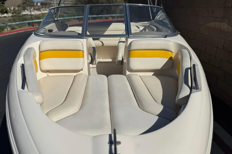 Slide: The Image of 2003 Rinker 192 Captiva Bowrider boat interior with white and yellow seating. - 9