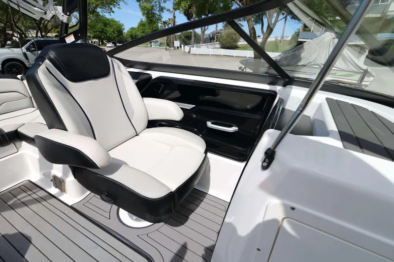 Slide: The Image of Interior of 2017 Yamaha Boats 212X, featuring sleek seating and modern design elements. - 12