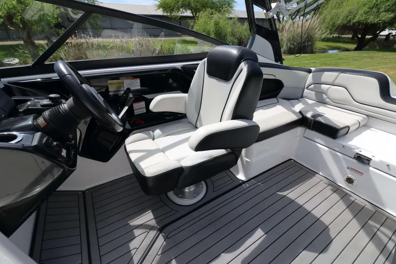 Slide: The Image of Interior of 2017 Yamaha Boats 212X, featuring sleek seating and modern steering console. - 13