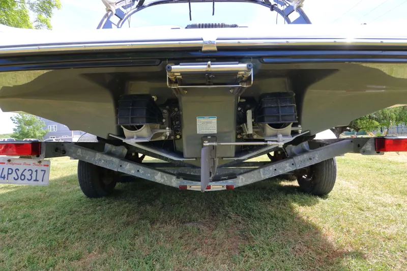 Slide: The Image of Rear view of a 2017 Yamaha Boats 212X on a trailer, showcasing dual engines. - 6