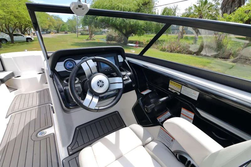 Slide: The Image of 2017 Yamaha Boats 212X cockpit with steering wheel and dashboard controls. - 9