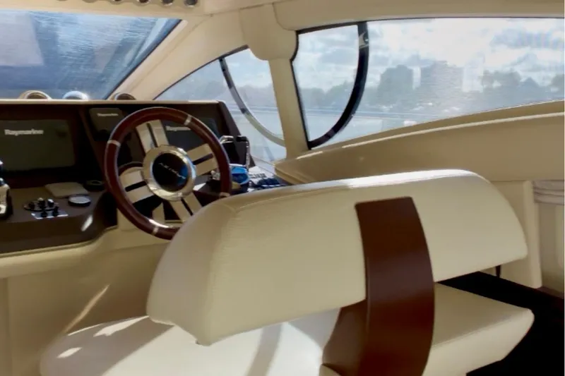 Slide: The Image of Interior of a 2014 Azimut 48 yacht cockpit with steering wheel and controls. - 10