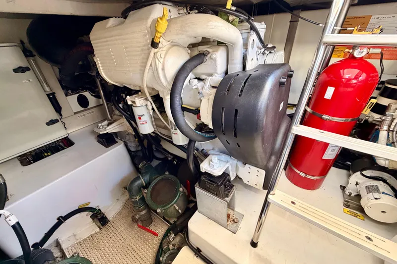 Slide: The Image of Engine room of a 2014 Azimut 48 yacht, featuring machinery and safety equipment. - 14