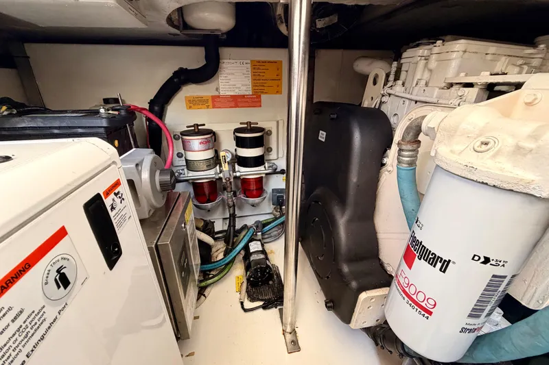 Slide: The Image of Engine room of a 2014 Azimut 48 yacht, showcasing mechanical components and filters. - 16