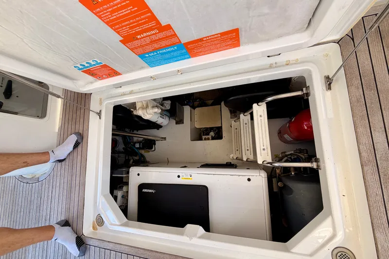 Slide: The Image of Engine compartment of a 2014 Azimut 48 yacht, featuring equipment and safety labels. - 18