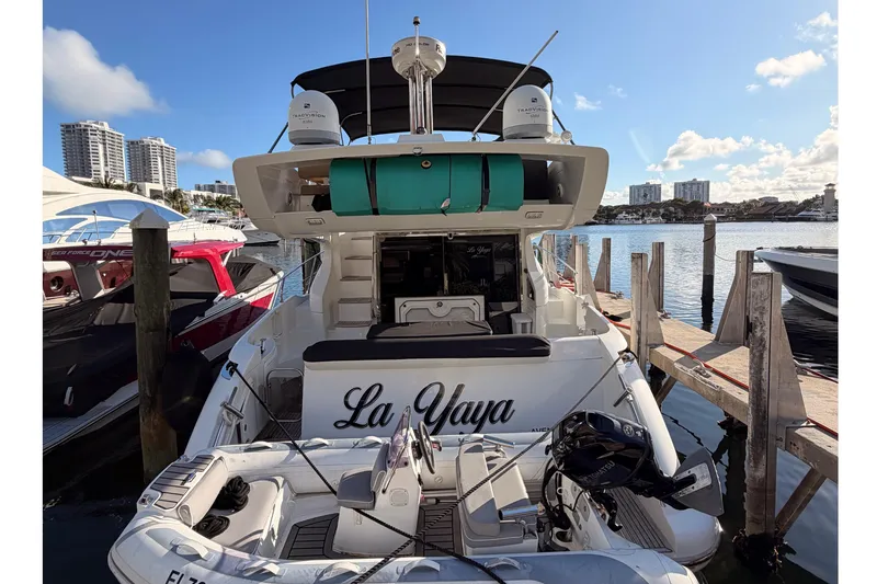 Slide: The Image of 2014 Azimut 48 yacht docked at marina, sunny day, city skyline in background. - 2