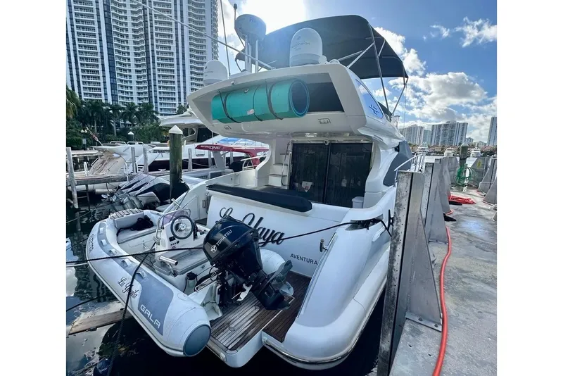 Slide: The Image of 2014 Azimut 48 yacht docked at marina with inflatable boat and city skyline. - 3