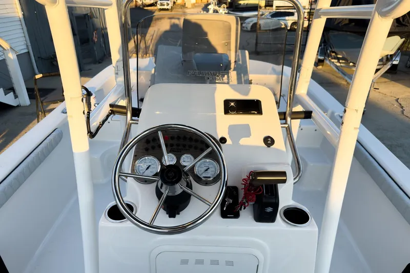 Slide: The Image of 2026 Carolina Skiff 19 LS boat dashboard with steering wheel and gauges. - 18