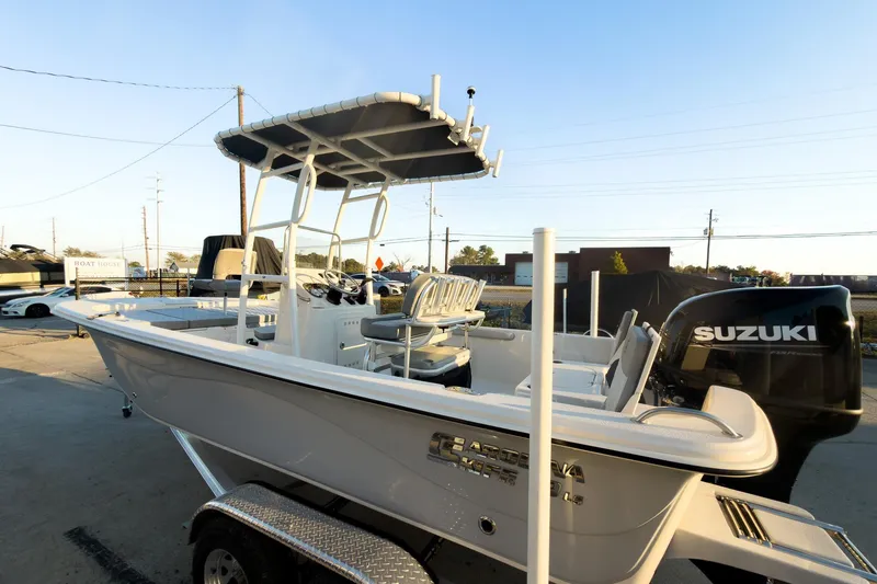 Slide: The Image of 2026 Carolina Skiff 19 LS boat with Suzuki engine on trailer, outdoor setting. - 3