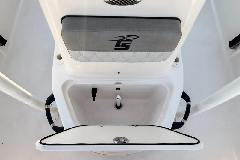 Slide: The Image of 2026 Carolina Skiff 19 LS boat interior with storage compartment and cushioned seat. - 34