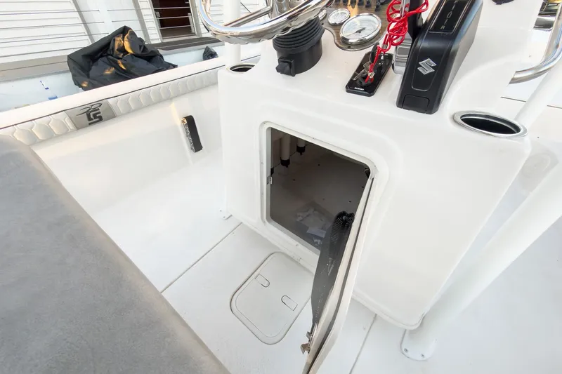 Slide: The Image of 2026 Carolina Skiff 19 LS boat console with open storage compartment and control panel. - 35