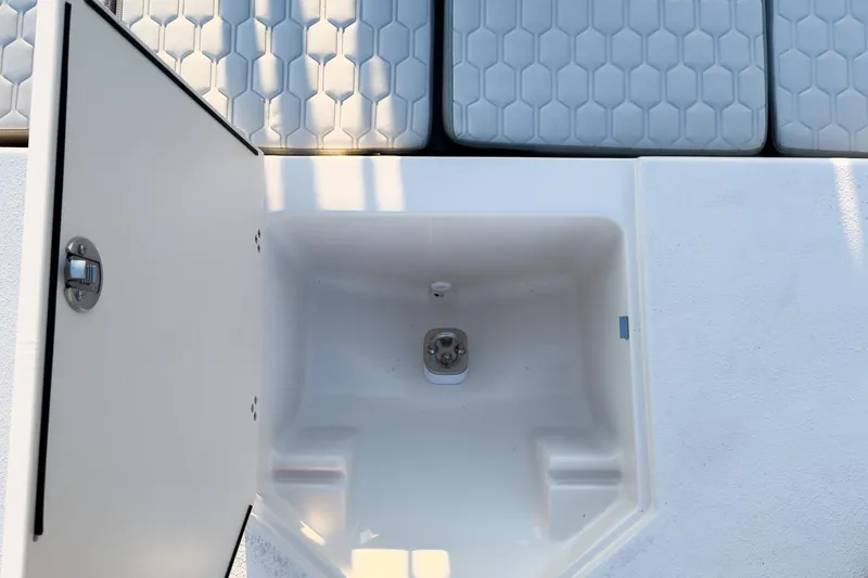 Slide: The Image of Open storage compartment on 2026 Carolina Skiff 19 LS boat with cushioned seating. - 36